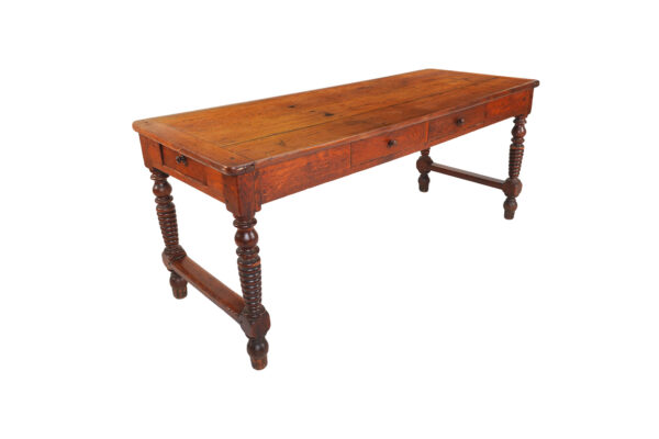 Oak farm table with two drawers, resting on turned legs joined  By a cross brace