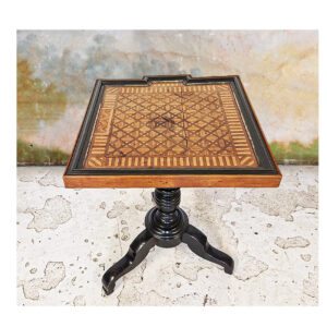 Pedestal table in blackened wood and light wood veneer with inlaid lattice and geometric motifs